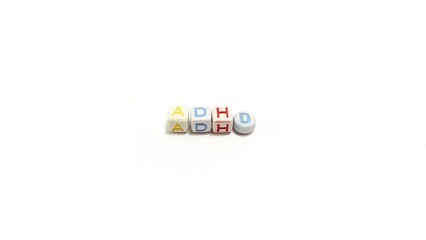 ADHD in alphabet beads on white background with copy space. An empty space for banner wallpaper.