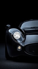 Fototapeta premium Sleek Black Classic Sports Car Headlight Detail