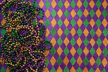 Mardi Gras Beads and Diamonds. Colorful beads and harlequin background © vetre