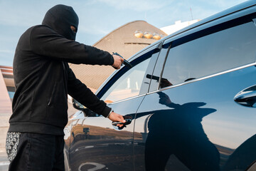 Kidnapping attempt from a car, masked criminal points a gun at the driver