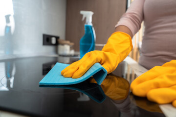 Housekeeper cleaning the kitchen, gas stove, cleanliness concept