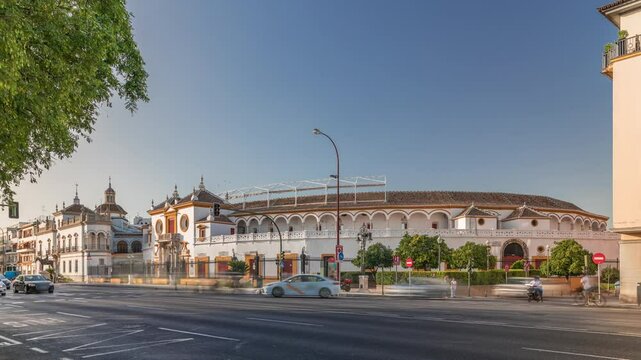 Plaza de Toros de la Real Maestranza de Caballeria de Sevilla timelapse hyperlapse. Historic bullring in Seville, Spain, known for its bullfighting festivals. Traffic passing in front of its facade