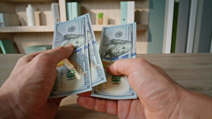 Successful businessman calculating dollars cash at office workplace closeup. 