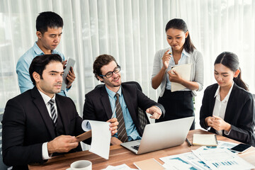 Diverse of business people from various ethnic group working in modern office environment. Productive and multi ethnic office workers engage in discussion for strategic business marketing. Meticulous