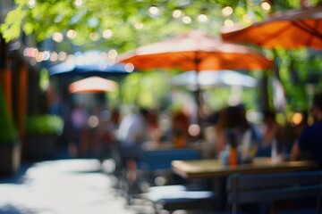 Fototapeta premium Blurred Sunny Day Cafe Scene: Outdoor Seating Under Umbrellas