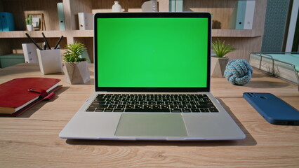 Fototapeta premium Hand browsing website greenscreen laptop at home closeup zoom in. Unknown man