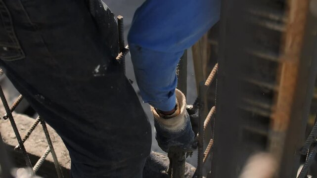 Worker with concrete vibrator on construction site