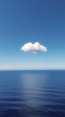Beautiful cloud floating over calm ocean waters under a clear blue sky