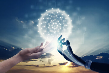 Woman and robot touching data network against sunset sky, closeup of hands. Concept of...
