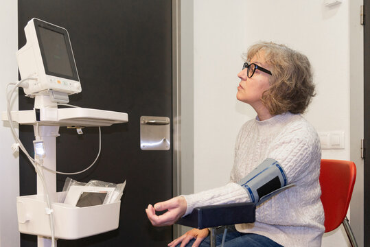 Mature woman having a blood pressure test in a clinic