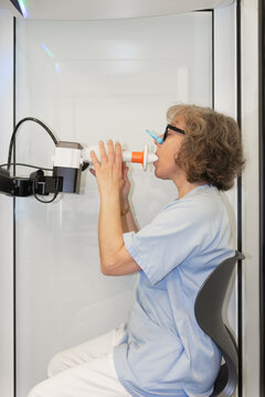 Female patient undergoing spirometry test in medical setting