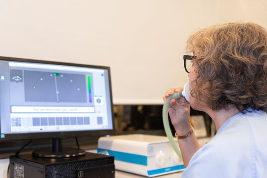 Woman performing a spirometry test in a pneumology lab