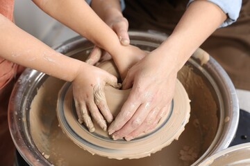 Hobby and craft. Mother with her daughter making pottery indoors, closeup