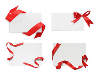 Blank cards with red ribbon and bow isolated on white, top view