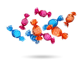 Candies in bright wrappers falling on white background