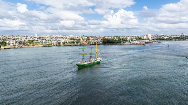 Santo Domingo, Dominican Republic, aerial view of the three masted square rigger Alexander von Humboldt 2, a German sailing ship, is leaving port with city of Santo Domingo in background  