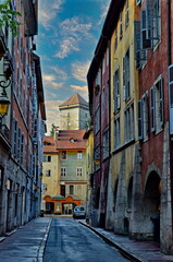 Annecy is an old city in eastern France. Reflections of colored houses in the river and flowers along the embankment.