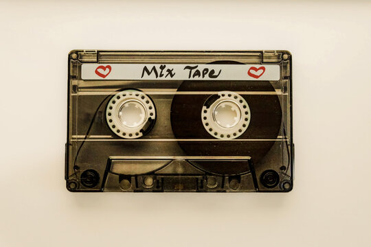 close-up of a transparent black audio cassette mix tape with writing and hearts music retro valentine love language nostalgia 80s favorite songs theme