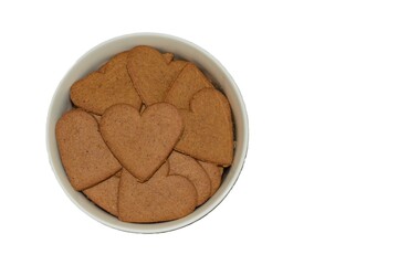 A lot of homemade heart shape cookies in a bowl isolated top view. Cooking Valentines biscuits. Baking handmade love day treats. Heart biscuits in a bowl.