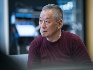 Thoughtful Older Asian Man Maroon Sweater - Leadership & Mentorship