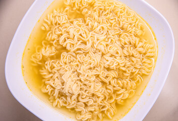 Instant asian soup with boiled noodles and chopsticks