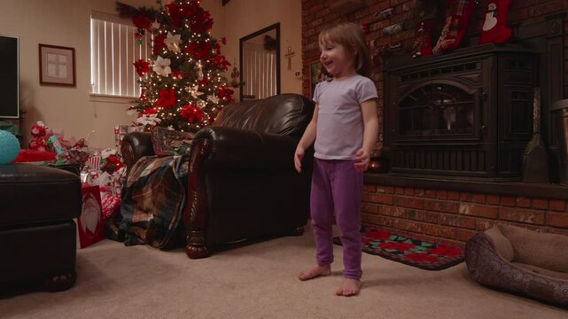 Little Girl Playing Catch with a Ball on Christmas