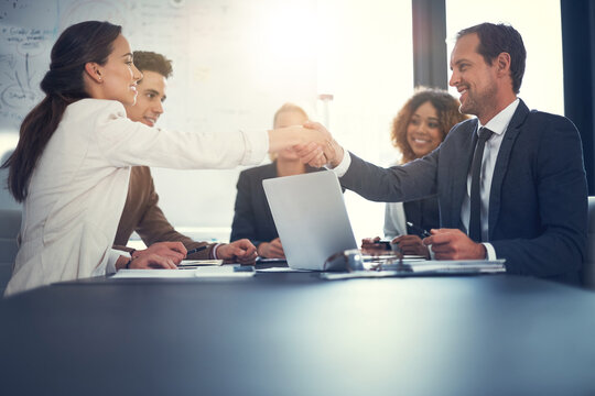 Office, meeting and business people with handshake for agreement, sales partnership and b2b success. Flare, employee and investor with shaking hands for company growth, investment deal and laptop