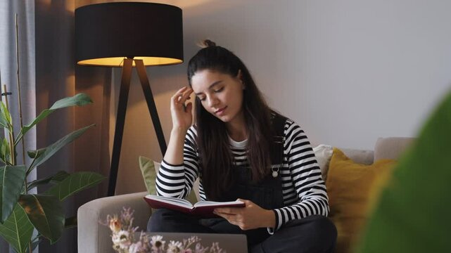 Sunlight pours in as a cheerful woman sits by the window, thoughtfully journaling for clarity and self-growth. A perfect blend of mindfulness, mental wellness, and cosy home vibes