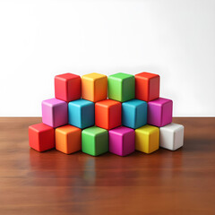 Obraz premium A set of colored cubes stacked in a pyramid on a wooden table, symbolizing diversity, development and potential