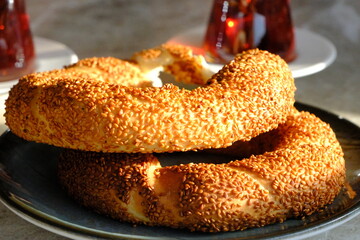 Close-up view of traditional Turkish street food simit with pastry and tea. two bagels and two glass glasses of tea. Snack. Turkish pastries. Fast food.