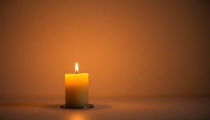 A single lit candle on a brown background