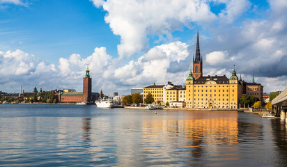 Fototapeta premium Stockholm, Sweden - 1 October 2022: Gamla Stan, old town in Stockholm at sunset with Riddarholmskyrkan church 