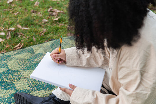 Outdoor sketching session in a park, focusing on creativity