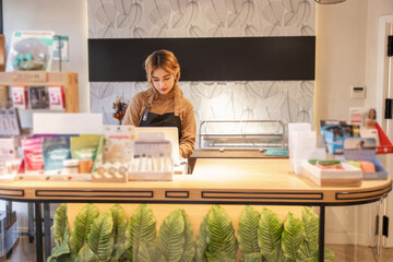 Female employee working in a modern cosmetics store interior