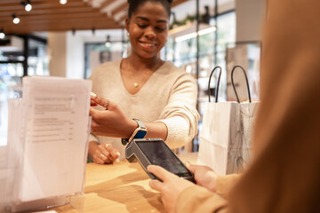 Customer making contactless payment in a modern cosmetics store