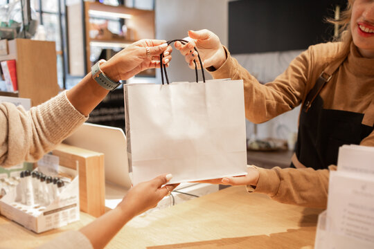 Customer and worker engaging in a cosmetics store transaction