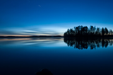 A calm, tranquil lake on a spring night in the forests of Finland
