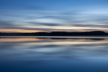 A calm, tranquil lake on a spring night in the forests of Finland