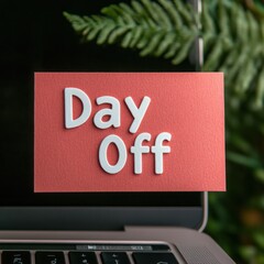 Creative reminder card with the text Day Off placed on a laptop keyboard showcasing the concept of work-life balance and leisure time in a modern workspace
