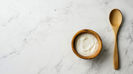 Wooden bowl with cream on marble background