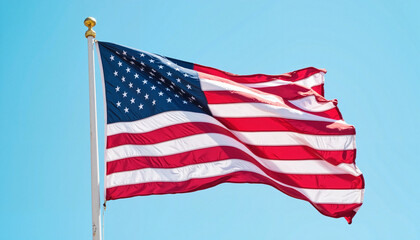 Obraz premium American flag waving in the wind against blue sky, patriotic symbol