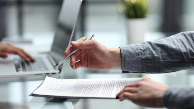 Working with documents at the desk in close-up in the office