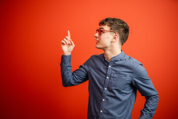 portrait of man stand and show red background behind him studio shot