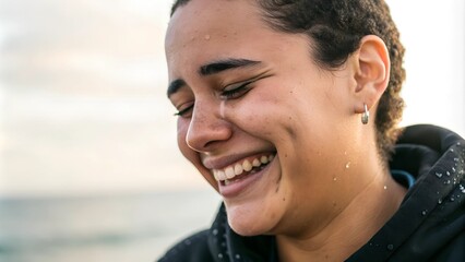 Delighted person laughing with tears of joy against a scenic outdoor backdrop of nature
