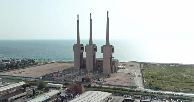 Aerial view industrial urban landscape les tres xemeneies Barcelona. A chemical plant on the shores of the Mediterranean Sea in Spain. High quality 4k footage