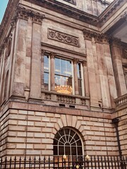 classic architecture of timeless beauty of a historic liverpool building. Its intricate stonework, warm sandstone tones, and the soft glow from the chandeliers adds a touch of elegance.