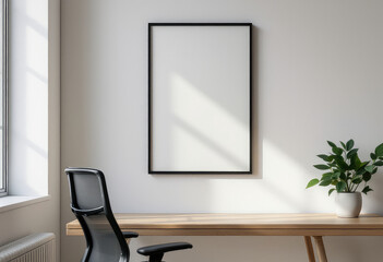 A black office chair sits in front of a wooden desk, with a white plant in a white pot and a blank black frame on the wall above. A4 frame mockup