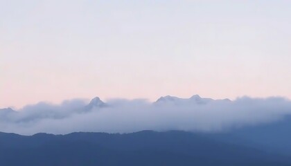 Fototapeta premium Misty Mountains Under a Pale Sky at Dawn