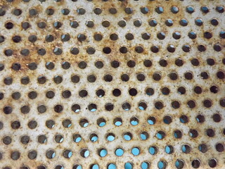 Corroded metal sheet with perforations