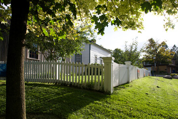 House exterior with a white picket fence in springtime